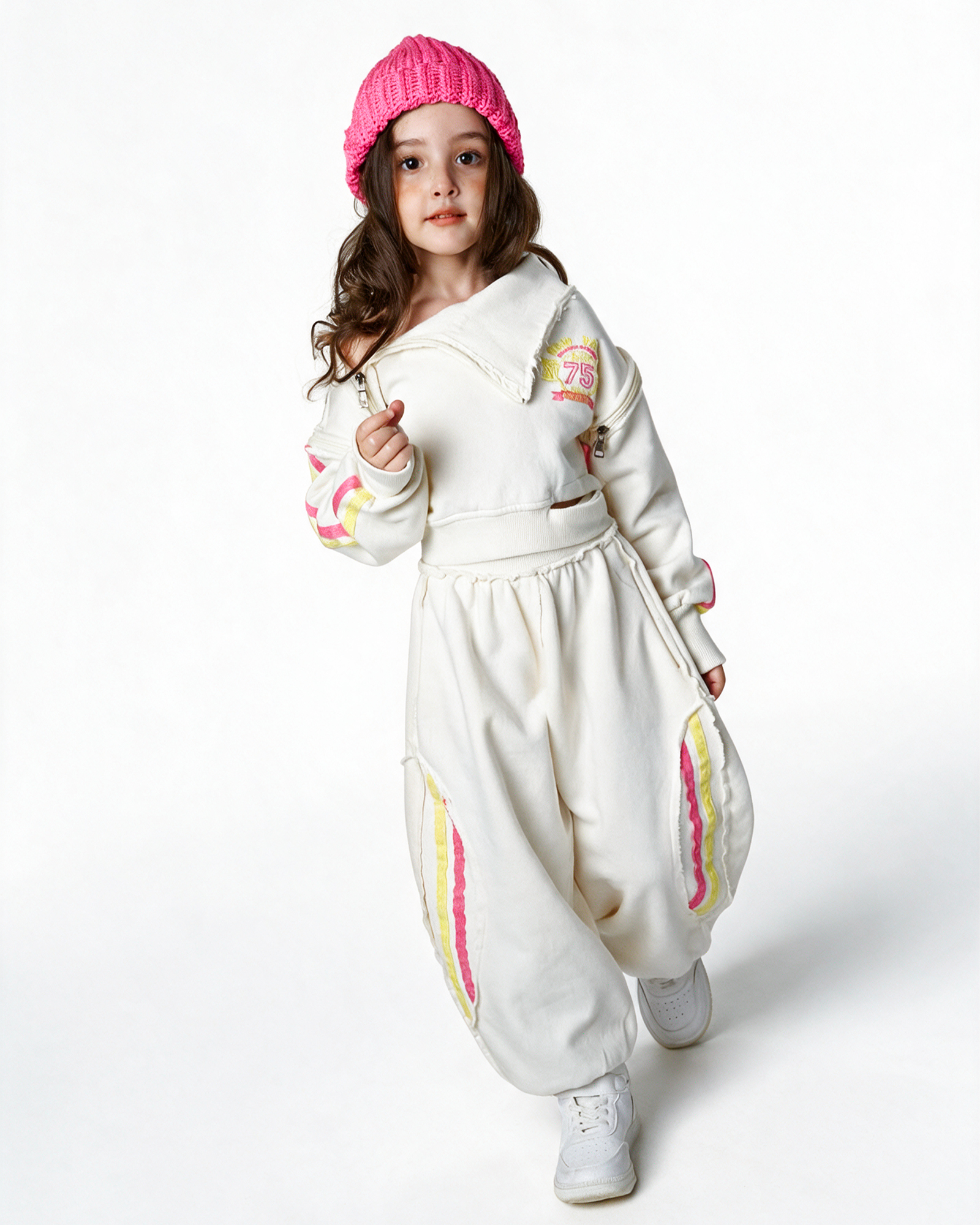 Girl in an off-white winter set with colourful details and a pink beanie, from Stedrino