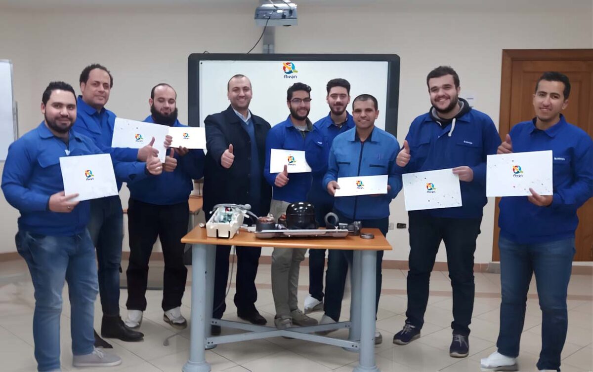 Group of Awan trainees holding training certificates in a classroom