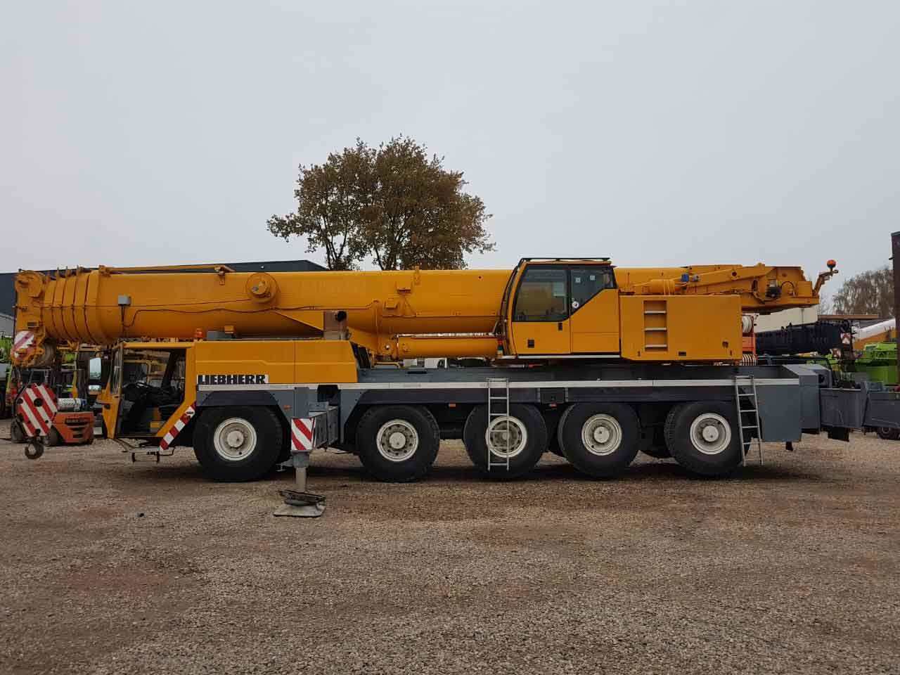El Masria Petroleum Services – Hassan Al Dibiky 2 Yellow Liebherr mobile crane parked in a yard, side view