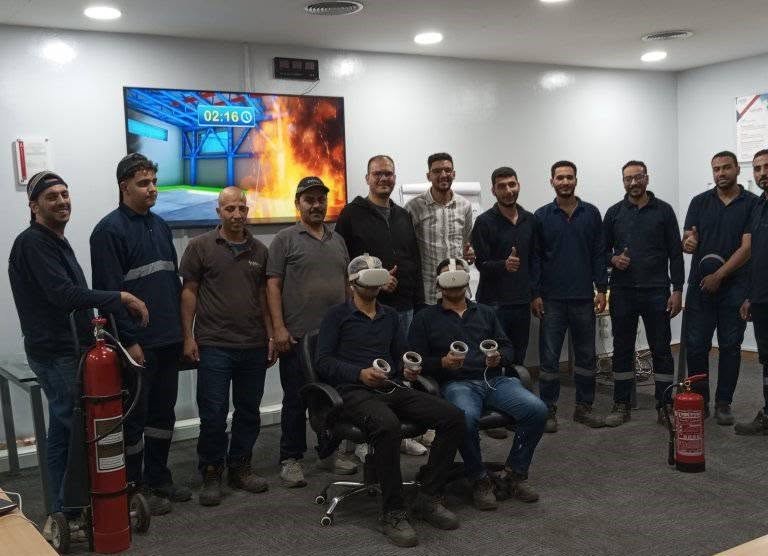 Awan 3 Workers at a VR firefighting training session with headsets and a fire extinguisher